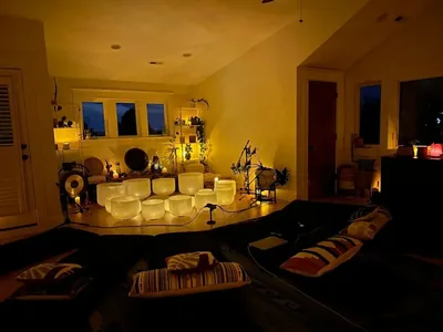 The Attic: dormer windows at dusk, warm lamps, a ring of crystal bowls on a rug